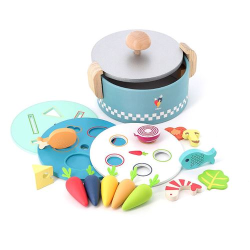 A blue wooden cooking pot with a silver lid, accompanied by colorful wooden vegetables and shapes, including carrots, fish, and a chicken, all designed for learning play.