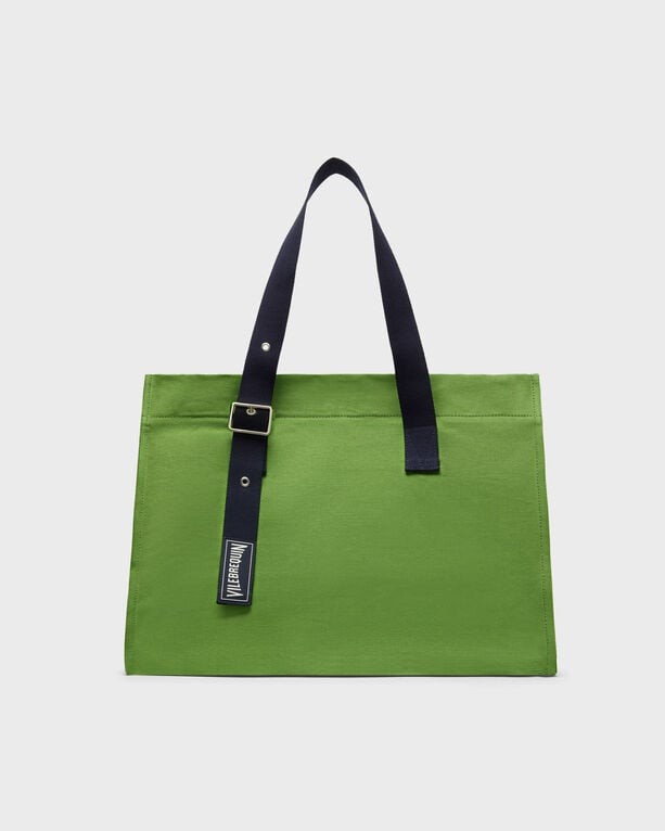 Green canvas beach bag with navy blue straps and a buckle detail, featuring a rectangular shape and a large main compartment, ideal for beach essentials.