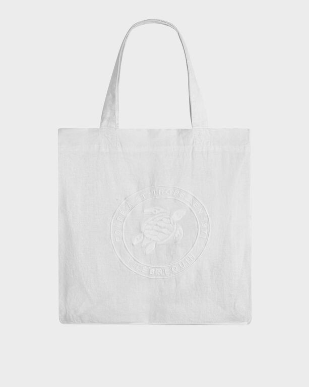 White linen tote bag featuring an embossed turtle design and sturdy handles, perfect for beach outings. Size OSFA.