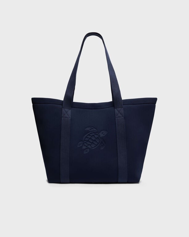 Solid blue neoprene beach bag with two sturdy handles and an embossed turtle logo on the front, designed for versatile beach use.