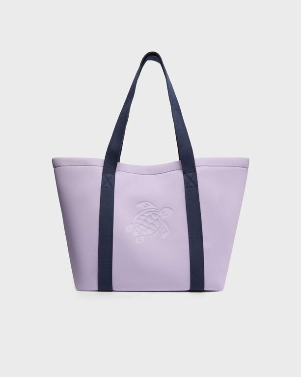 Purple neoprene beach bag with navy blue handles, featuring an embossed turtle design on the front, designed for versatile beach use.