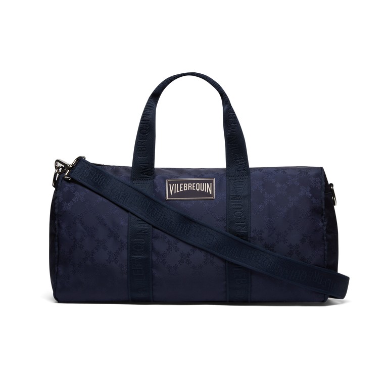 Blue travel bag by Vilebrequin featuring a turtle monogram pattern, durable material, dual handles, and a detachable shoulder strap. Size OSFA.