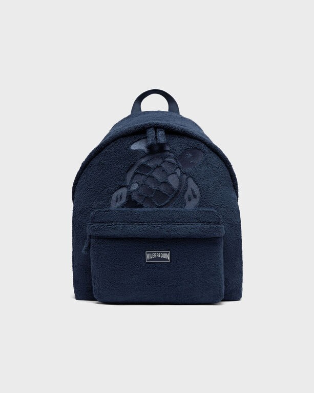 Blue terry fabric unisex backpack featuring a turtle design, a front pocket, and a top handle, ideal for casual use.