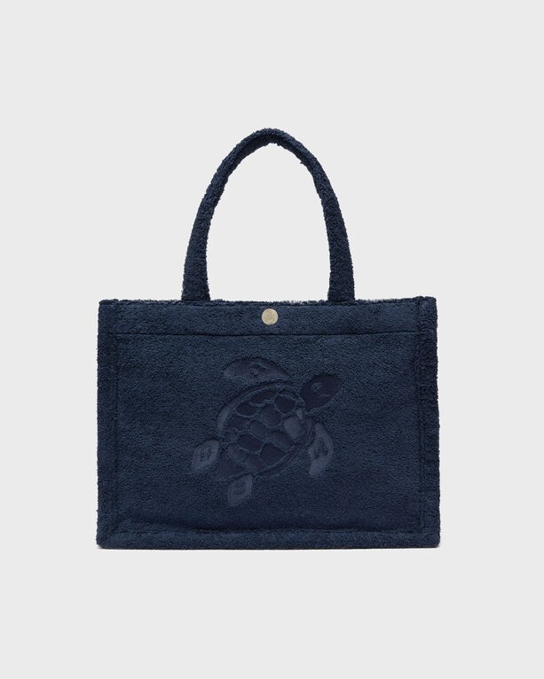 Blue terry beach bag by Vilebrequin featuring a textured surface, embroidered turtle design, and sturdy handles, ideal for summer outings.