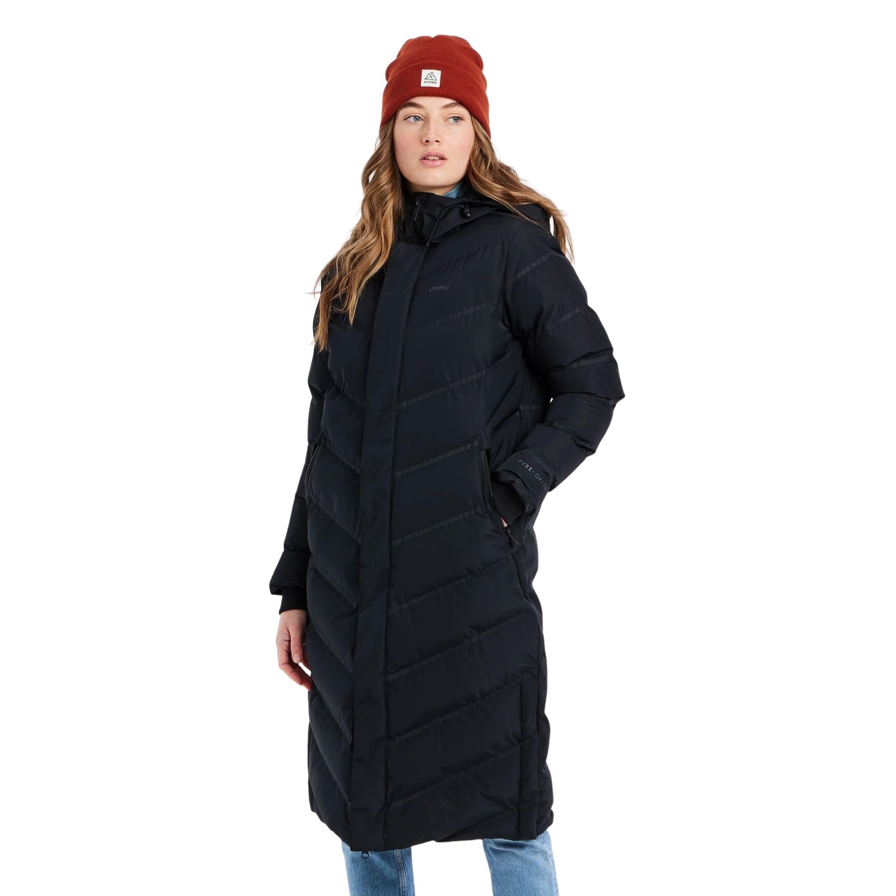 Long black puffer coat with a chevron pattern, high collar, and zippered front, paired with a red beanie, worn by a woman standing casually.