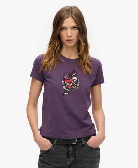 Purple fitted T-shirt featuring a colorful tattoo-style rhinestone graphic on the front, made from soft material, available in size 10.