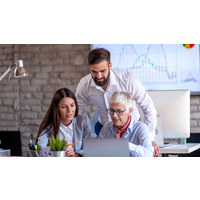 "Decision Making course cover showing three people collaborating at a desk with a laptop and charts in the background"