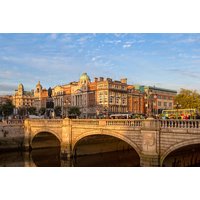 Dublin Citi Hotel offer with breakfast, Prosecco, view of historic city buildings and stone bridge over river.