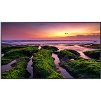 Samsung 75" digital signage flat panel with slim black bezel, displaying vibrant sunset over rocky shoreline.