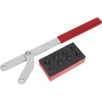 Universal pulley and fan clutch holder set with red-handled adjustable wrench and black block with multiple fittings.
