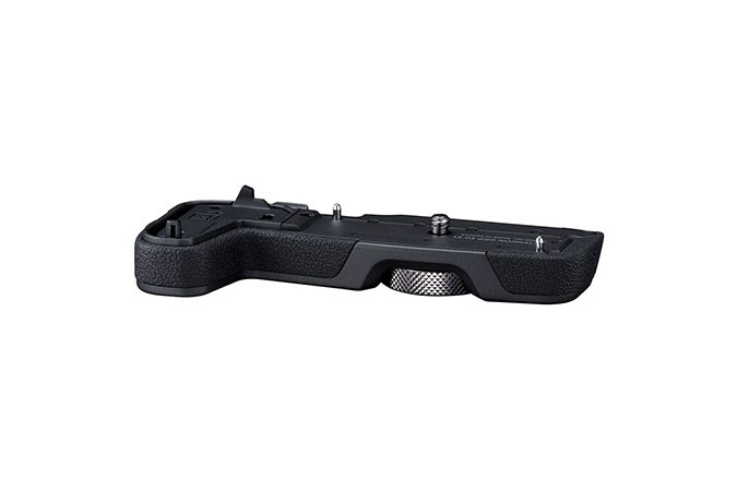 Black Canon EG-E1 Extension Grip with textured rubber surface, featuring a silver button and mounting points for secure attachment to a camera.