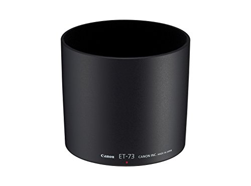 Black Canon ET-73 lens hood with a smooth exterior, featuring a red dot indicator and engraved branding, designed to reduce lens flare and protect the lens.