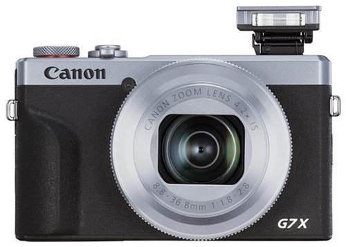 Silver Canon PowerShot G7 X Mark III compact camera featuring a sleek design, a prominent lens, and a pop-up flash, with a textured black grip for easy handling.