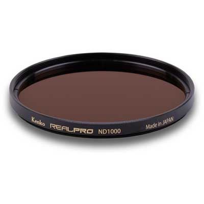 Kenko 67mm REALPRO ND1000 filter with a dark brown glass surface, encased in a black metal frame, featuring gold lettering and "Made in JAPAN" inscription.