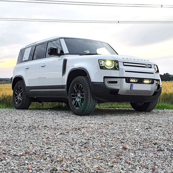 Lazer Lamps Grille Integration Kit features Gen 2 Triple-R 750 lamps mounted on a white SUV with black accents, showcasing a rugged design and enhanced visibility.