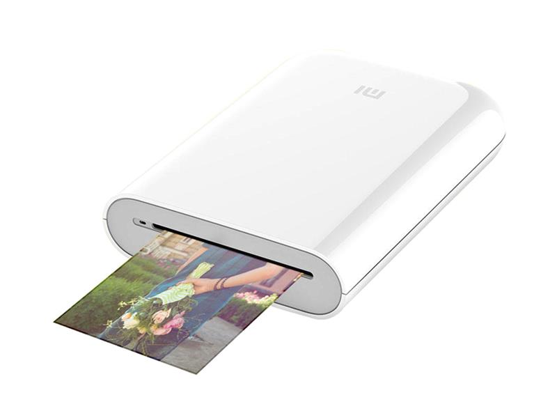 Compact white Mi Portable Photo Printer by Xiaomi, featuring a sleek design with a photo emerging from the output slot, ideal for on-the-go printing.