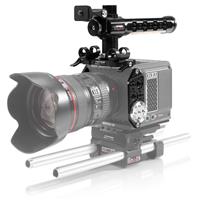 Black aluminum camera cage with a top handle, designed for the RED KOMODO, featuring multiple mounting points and a sturdy base with rods for stability.