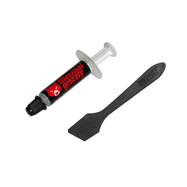 Black and red syringe of Thermal Grizzly Kryonaut thermal paste, labeled "12.5 W/mK," accompanied by a black plastic spatula for application.