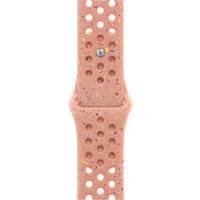 Pink Apple watch band with perforated fluoroelastomer material and speckled design, featuring a silver clasp.