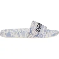 Children's Superdry slide with camo print, white and gray tones, featuring bold black "SUPERDRY" text on the strap.
