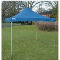 Blue Draper GAZ4 folding gazebo with pointed roof, four metal legs, and 3m x 3m size, set up on grass.