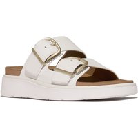 White leather two-bar sandals with gold buckles and cushioned sole.
