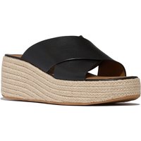 Black leather FitFlop women's sandals with crisscross straps and beige platform wedge sole.