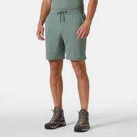 Green Helly Hansen men's shorts with drawstring waist, knee-length, lightweight fabric, worn by model with hiking boots.