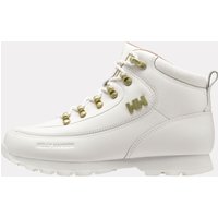 White Helly Hansen women's winter boots with gold eyelets, padded collar, and embossed logo.