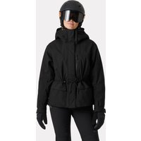 Black Helly Hansen women's ski jacket with hood, front zipper, and adjustable waist, worn with helmet and gloves.