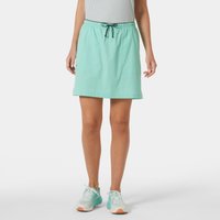 Green Helly Hansen hiking skort with drawstring waist, mid-thigh length, worn by a model, paired with sneakers.