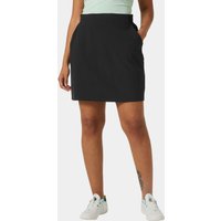 Black Helly Hansen women's Thalia Skirt 2.0, size S, knee-length with side pockets, worn by model with white sneakers.
