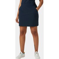 Navy blue Helly Hansen women's Thalia Skirt 2.0, knee-length with side pockets, worn by a model with white sneakers.