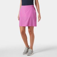 Pink Helly Hansen Women's Thalia Skirt 2.0, knee-length with side pockets, worn with navy top and gray sneakers.
