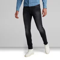 G-Star Revend skinny jeans, dark wash, slim fit, five-pocket style, worn with white sneakers and a blue shirt.
