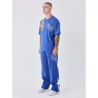 Blue Project X Paris jogging trousers with white side stripes and logo, paired with matching blue graphic T-shirt.