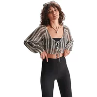 Ladies' checked knit cardigan, black and white pattern, cropped length, tie front, worn over black top.