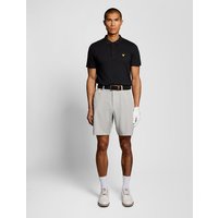 White Lyle & Scott men's golf shorts, 5-pocket design, tailored fit, worn with black polo and white golf shoes.