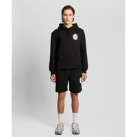 Black cotton sweat shorts with graphic badge on left leg, elastic waistband, and relaxed fit.