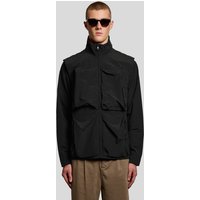 Black Lyle & Scott men's ripstop gilet with high collar, multiple front pockets, worn by a model in sunglasses.