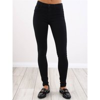 Black skinny fit jeans with a mid-rise waist and classic five-pocket design, worn with black loafers.