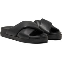 Black polyurethane women's mules with wide crisscross straps and flat soles.