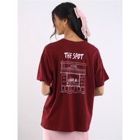 Zinfandel short-sleeve top with "THE SPOT" graphic on back, worn by model with long hair and pink ribbon.