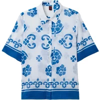 White Stefanel blouse with blue floral and geometric print, short sleeves, and button-up front.