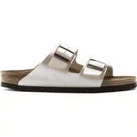 White Birkenstock Arizona sandals with dual adjustable straps and cork footbed.