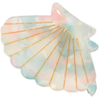 Shell-shaped hair clip with pastel marbled pattern and gold line accents.