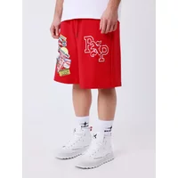 Red Project X Paris shorts with colorful patches and white logo, worn with white socks and sneakers.