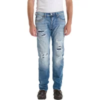 Blue slim jeans with distressed details and faded wash, worn by a model, by Le Temps des cerises.