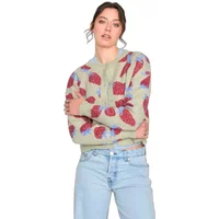 Green cardigan with red strawberry motifs, long sleeves, and ribbed cuffs, worn by a woman with light blue jeans.