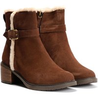 Dark brown suede ankle boots with buckle detail, faux fur trim, and stacked heel.
